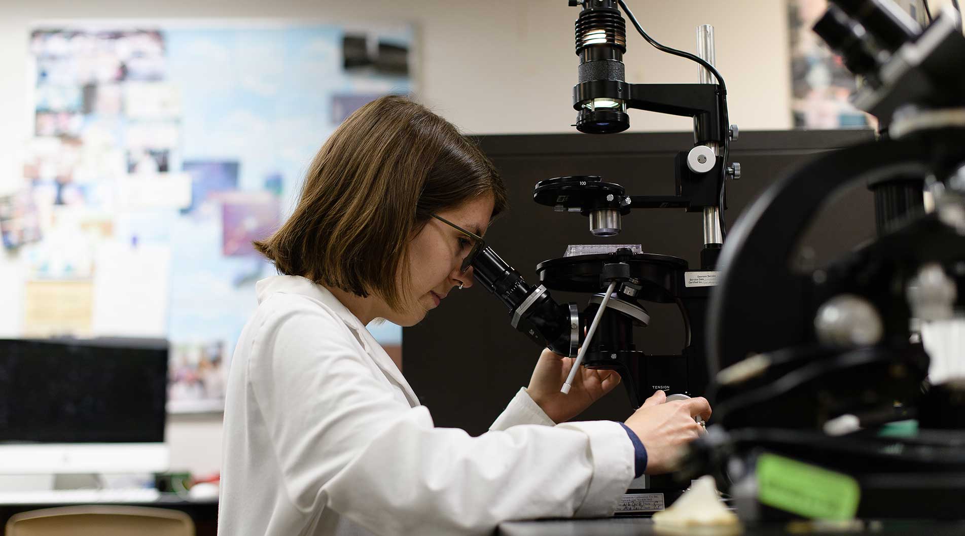 science student looking through a microscope