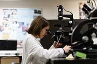 science student looking through a microscope